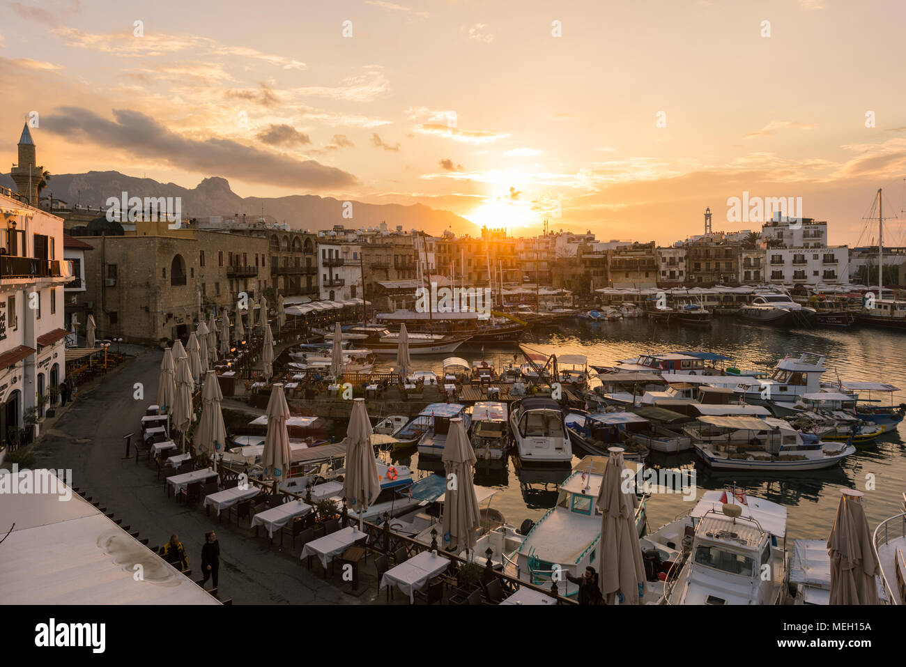 KYRENIA, CYPRUS - FEBRUARY 22, 2018: Old harbour of Kyrenia  during beautiful sunset. Stock Photo