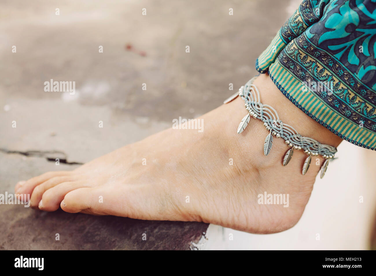 Female ankle with gypsy bracelet Stock Photo Alamy