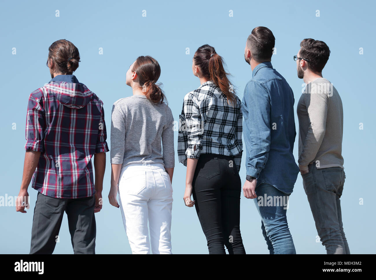 rear view.a group of young people looking at copy space Stock Photo - Alamy