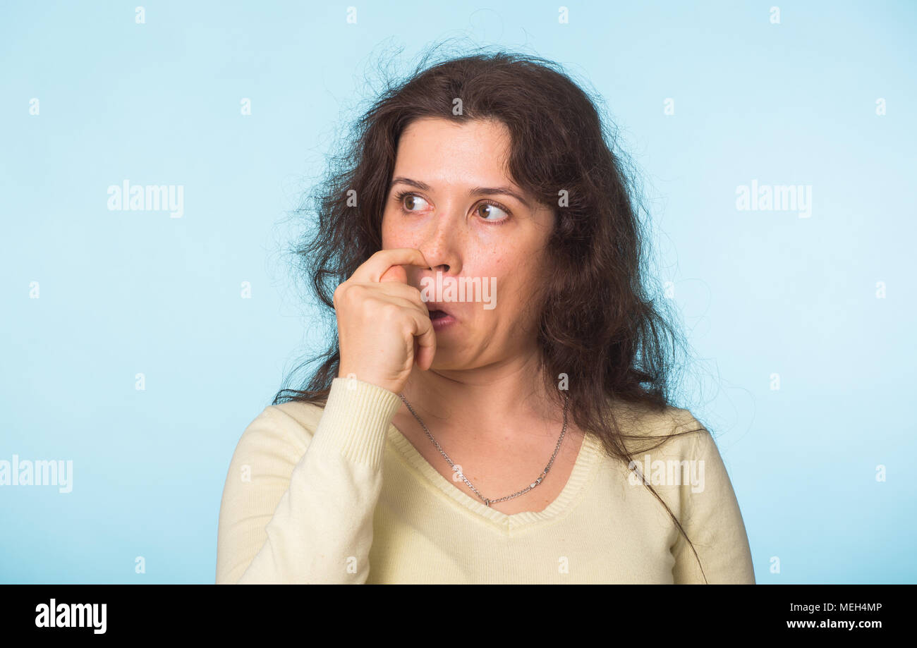 Woman picks his nose finger. Female climbs a finger in nose. Embarrassment Stock Photo