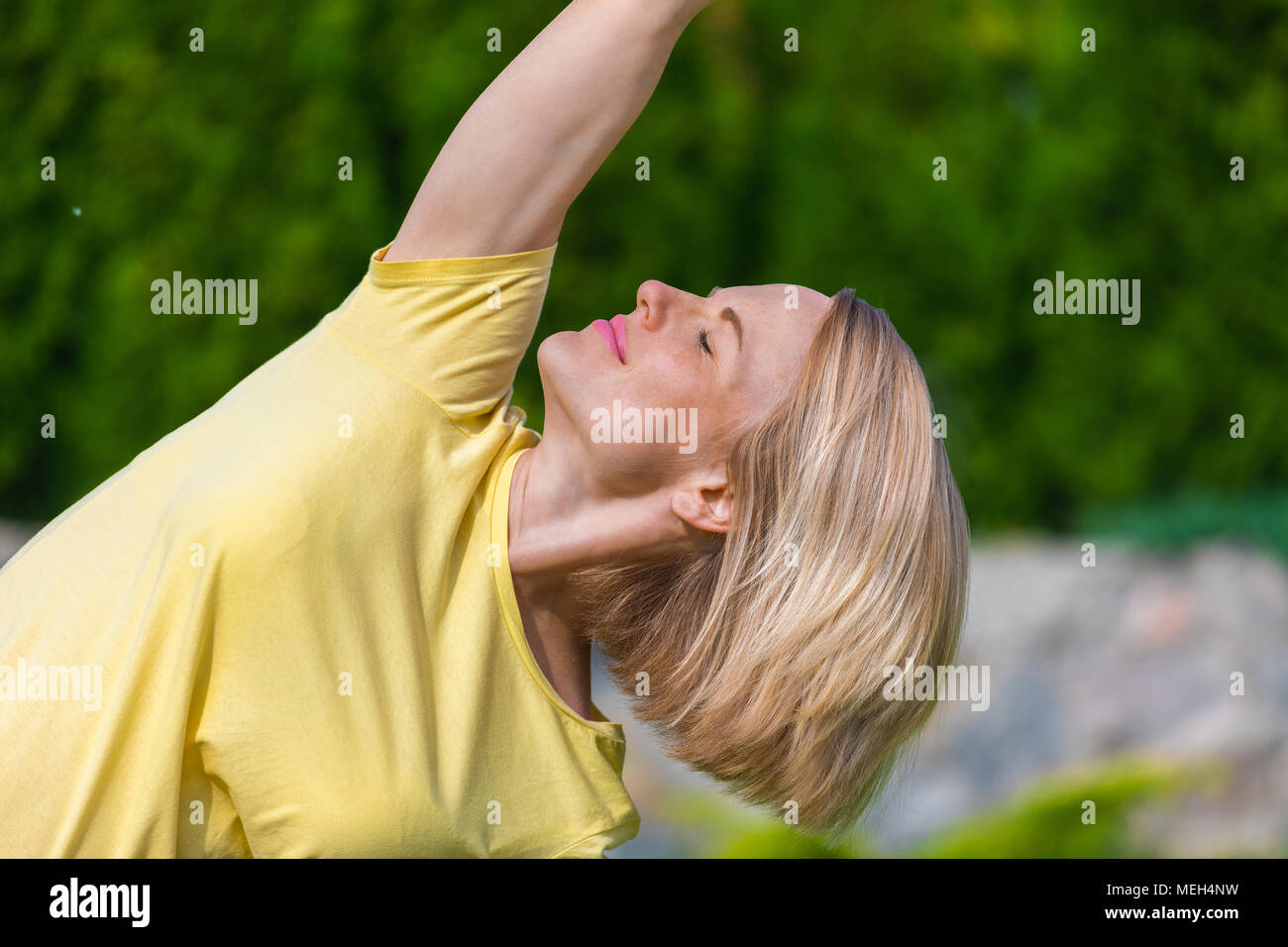 Beautiful Pregnant Woman Doing Prenatal Yoga On Nature Stock Photo - Alamy