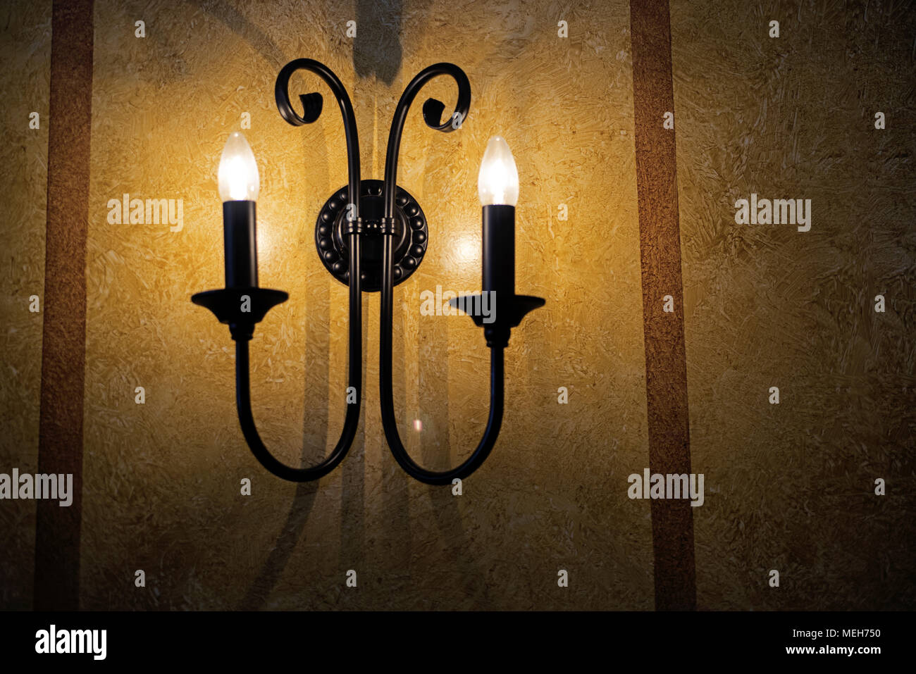 Decorative electric pendant on the wall. Abstract photo. Stock Photo