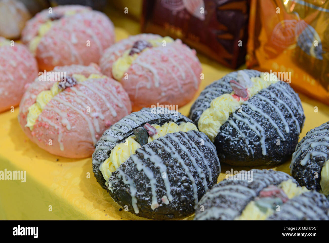 Model cream donuts on a stand at the China International Bakery Products Exhibition and trade fair in Beijing, China Stock Photo