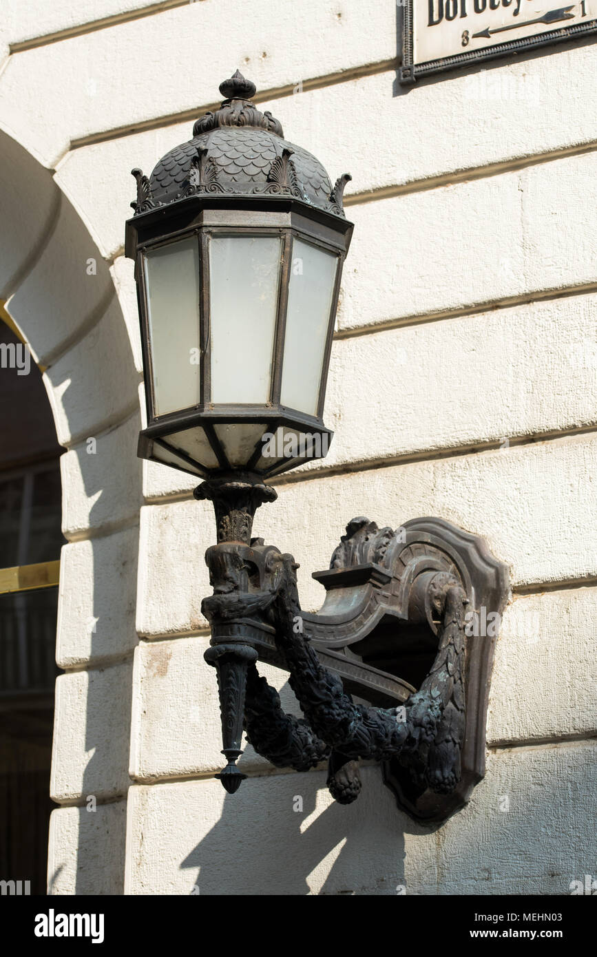 Decorative street lamp mounted on the facade of the building Stock