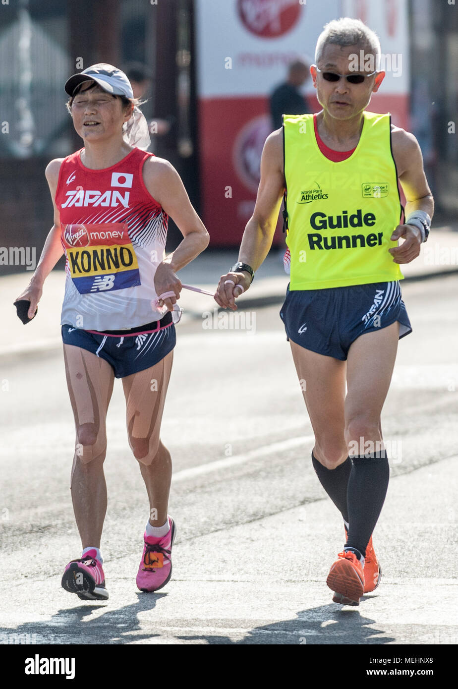 London, UK. 22nd April, 2018. Konno blind runner with her guide passes down Evelyn Street in Deptford during the 38th London Marathon. Credit: Guy Corbishley/Alamy Live News Stock Photo