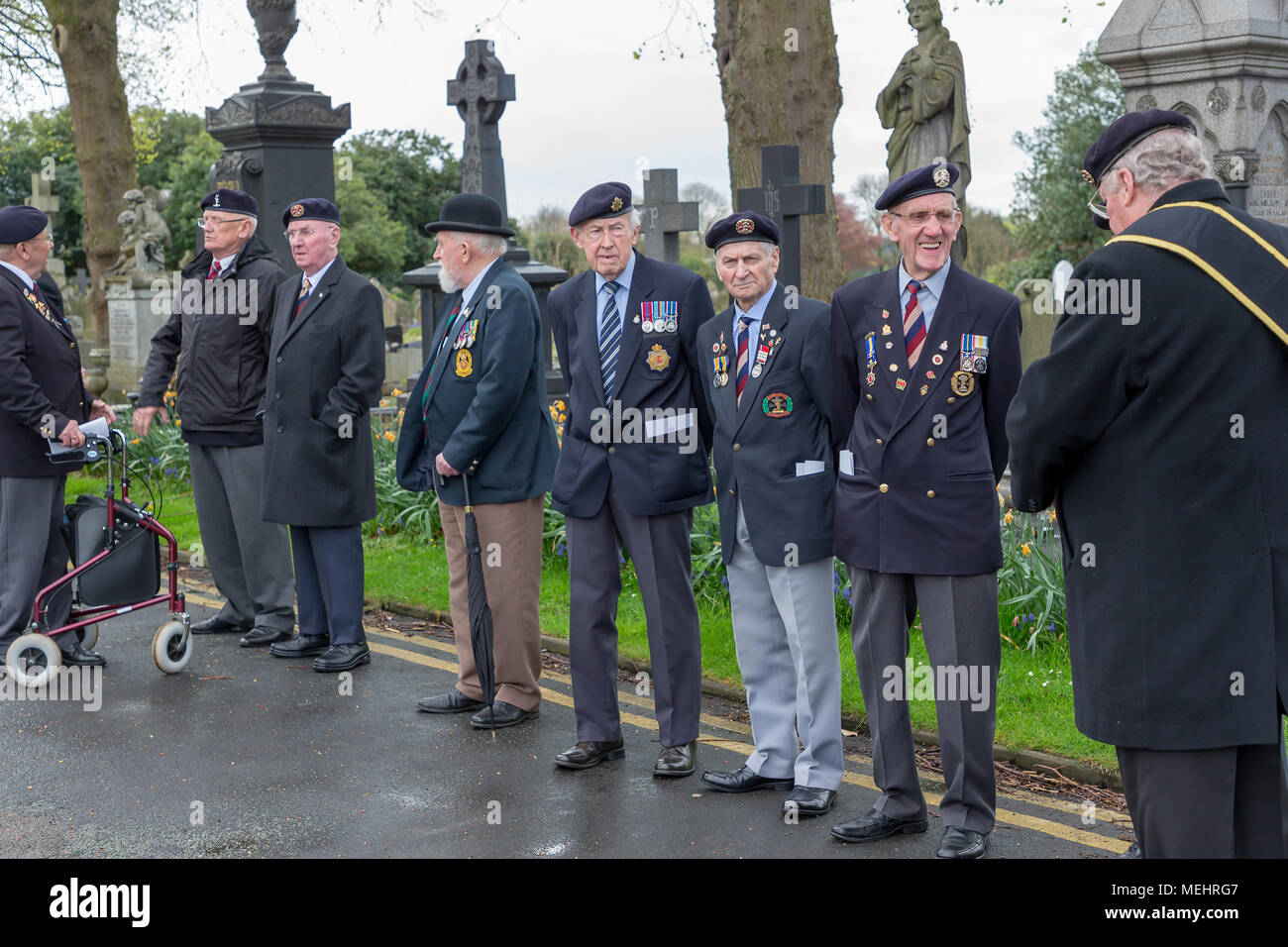 Ex-Servicemen stand in line at Soldiers' Corner waiting for the service to begin to commemorate the anniversary of ANZAC Day - Warrington, UK, 22 April 2018. The Anniversary of ANZAC Day has been commemorated on Sunday 22 April 2018 within Soldiers' Corner of Warrington Cemetery when the Deputy Mayor, Cllr Karen Mundry, Cadets from the Queen's Lancashire Regiment, Warrington Sea Cadets and many veterans were in attendance Credit: John Hopkins/Alamy Live News Stock Photo