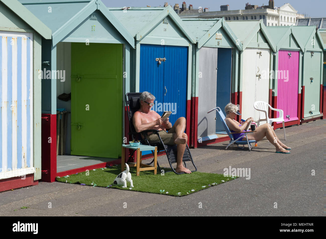Brighton residents enjoy their beach huts in the April sunshine. Brighton, UK, 22nd April 2018 Stock Photo