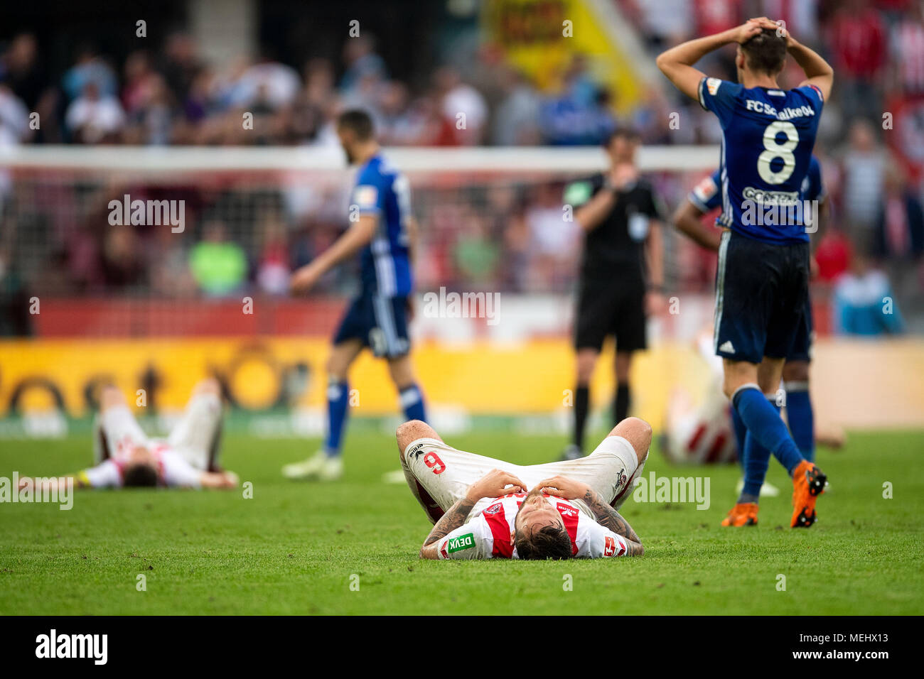 22 April 2018, Germany, Cologne: soccer, Bundesliga, 1. FC Koeln - FC Schalke 04, RheinEnergieStadio. Koeln's Marco Hoeger lying on the grass after the match. Photo: Marius Becker/dpa - IMPORTANT NOTICE: Due to the German Football League·s (DFL) accreditation regulations, publication and redistribution online and in online media is limited during the match to fifteen images per match Stock Photo