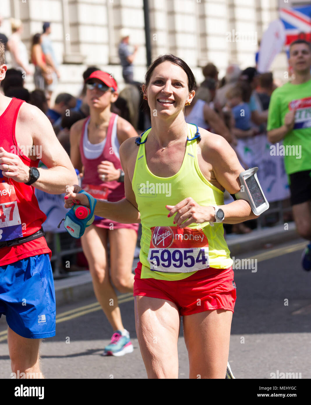 St James's Park, Birdcage Walk, London,UK. 22nd April, 2018. Elite and thousands of fun runners head towards Buckingham Palace in brilliant Spring sunshine as they enter the final mile of the 2018 Virgin London Marathon. Several of those taking part were affected by the one of the hottest Marathons days on record and needed the help of other runners to complete the final km as they approached the Mall whilst others were treated by first aid crews. Sadly one runner, Matt Campbell, aged 29, collapsed after 22.5 miles and died later in hospital . Credit: Alan Fraser Stock Photo