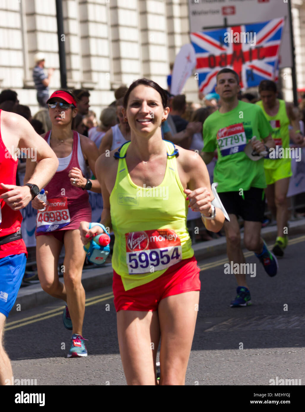 St James's Park, Birdcage Walk, London,UK. 22nd April, 2018. Elite and thousands of fun runners head towards Buckingham Palace in brilliant Spring sunshine as they enter the final mile of the 2018 Virgin London Marathon. Several of those taking part were affected by the one of the hottest Marathons days on record and needed the help of other runners to complete the final km as they approached the Mall whilst others were treated by first aid crews. Sadly one runner, Matt Campbell, aged 29, collapsed after 22.5 miles and died later in hospital . Credit: Alan Fraser Stock Photo