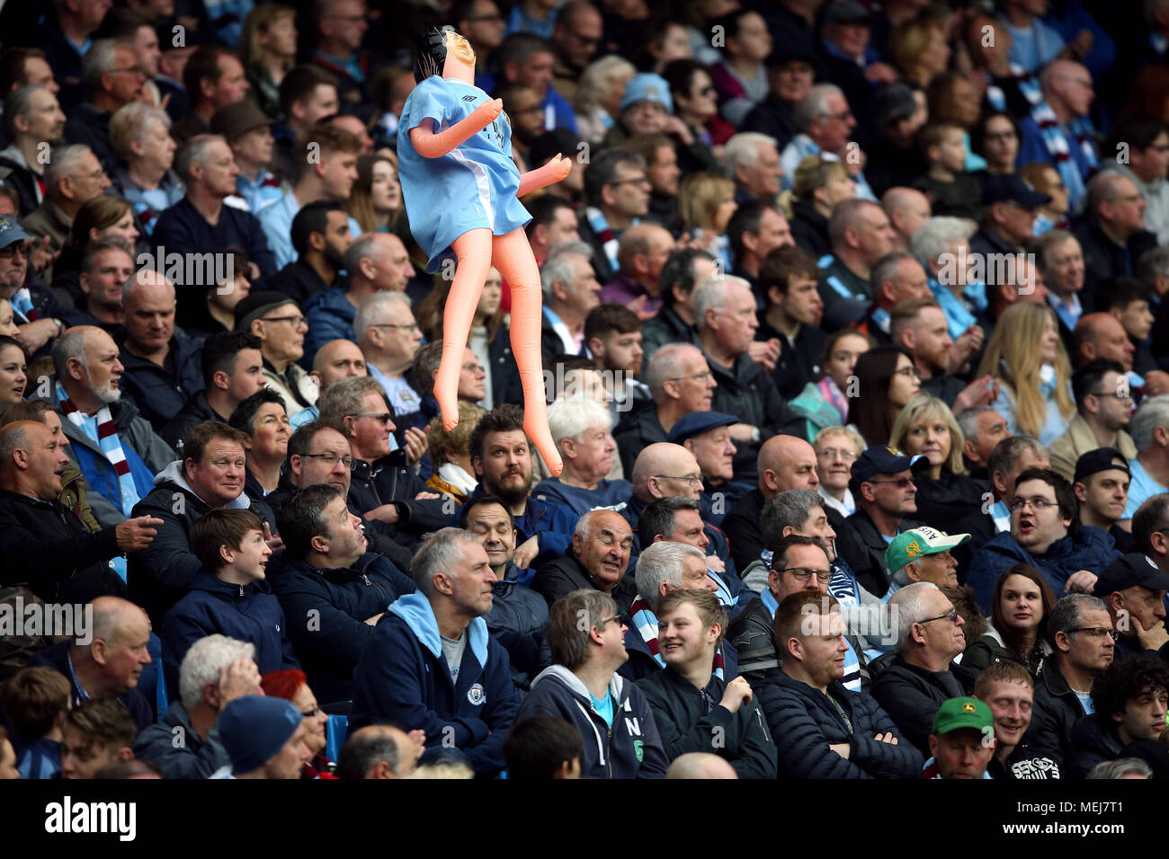 Manchester City fans hold up an inflatable doll in the stands during the Premier League match at the Etihad Stadium, Manchester. Stock Photo