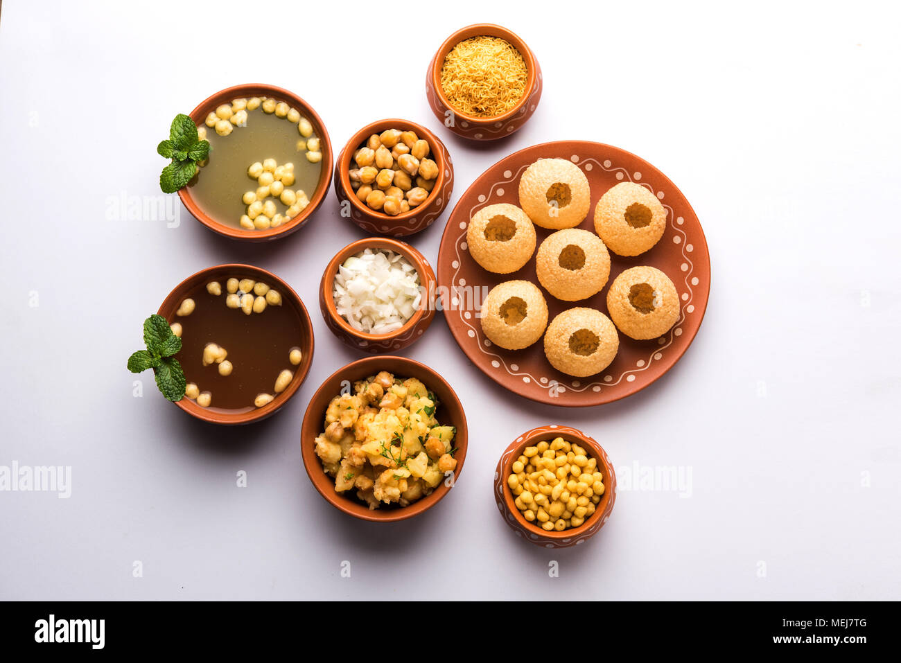 Pani Puri is Indian chat item served in a terracotta bowls and plate