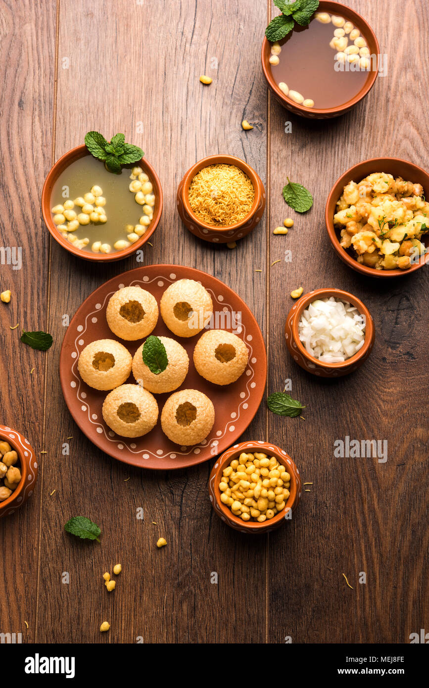 Pani Puri is Indian chat item served in a terracotta bowls and plate