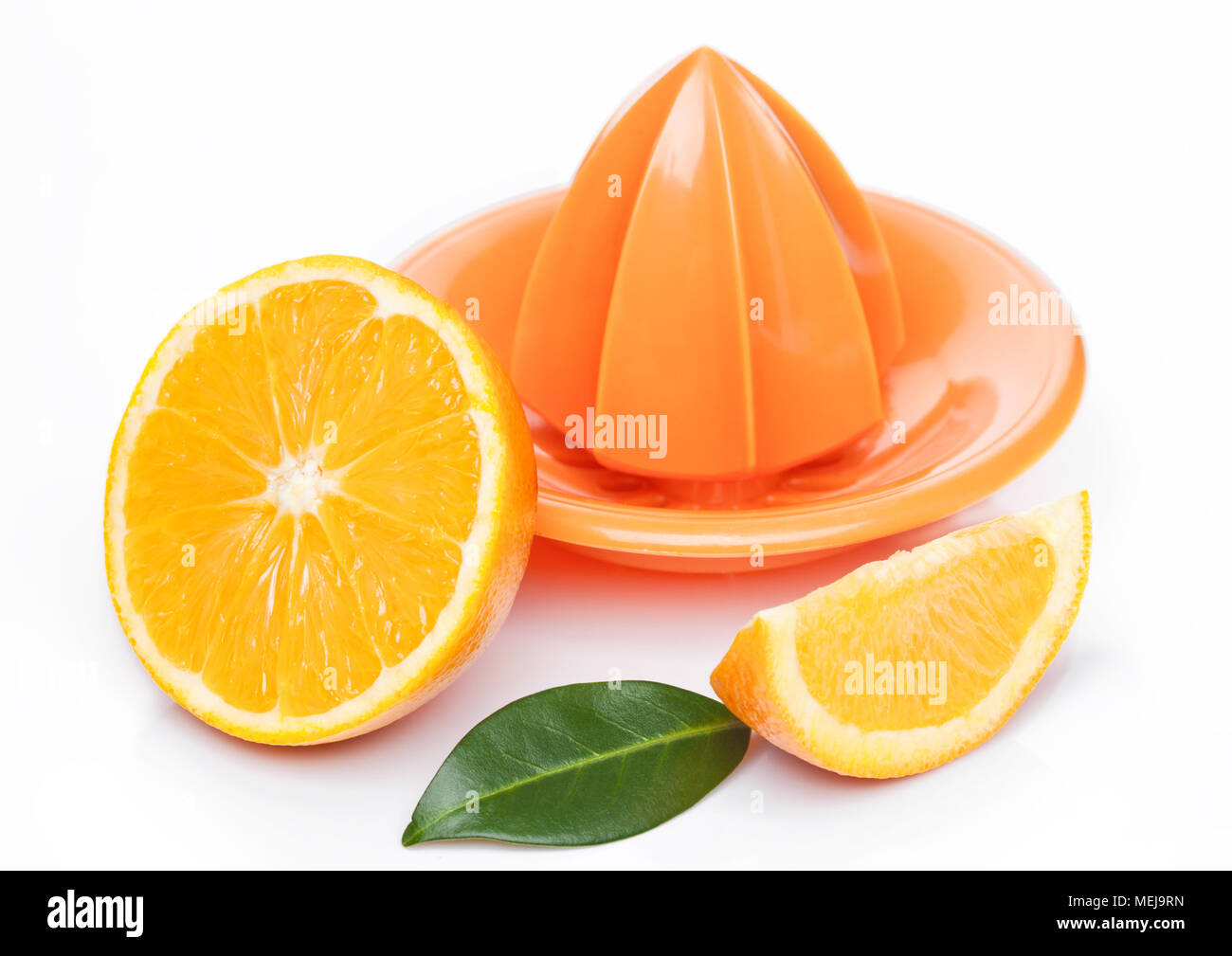 Fresh raw peeled oranges with juice squeezer with leaves on white background Stock Photo Alamy