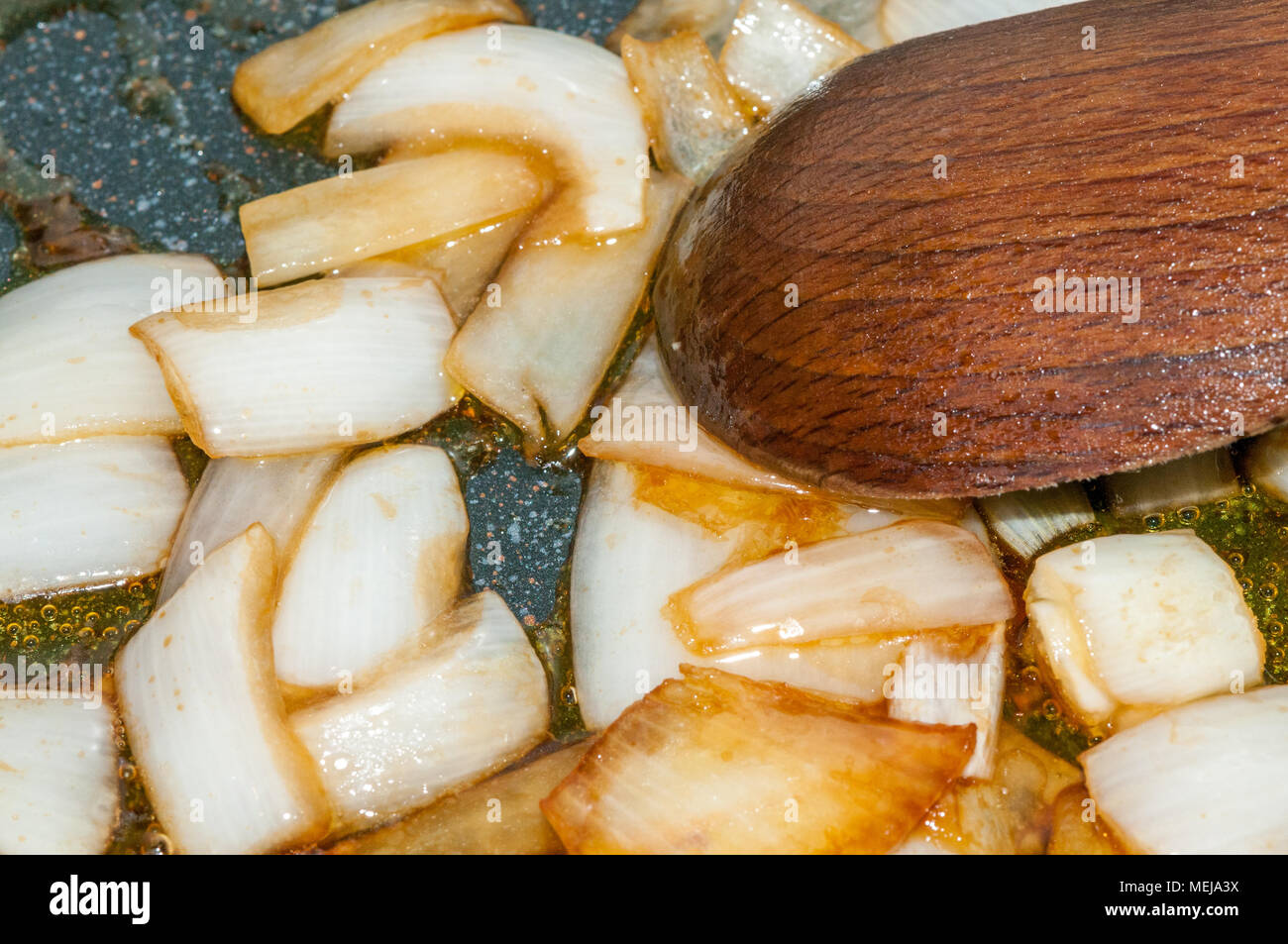 fried onion with soy sauce in the pan and wooden spoon Stock Photo Alamy