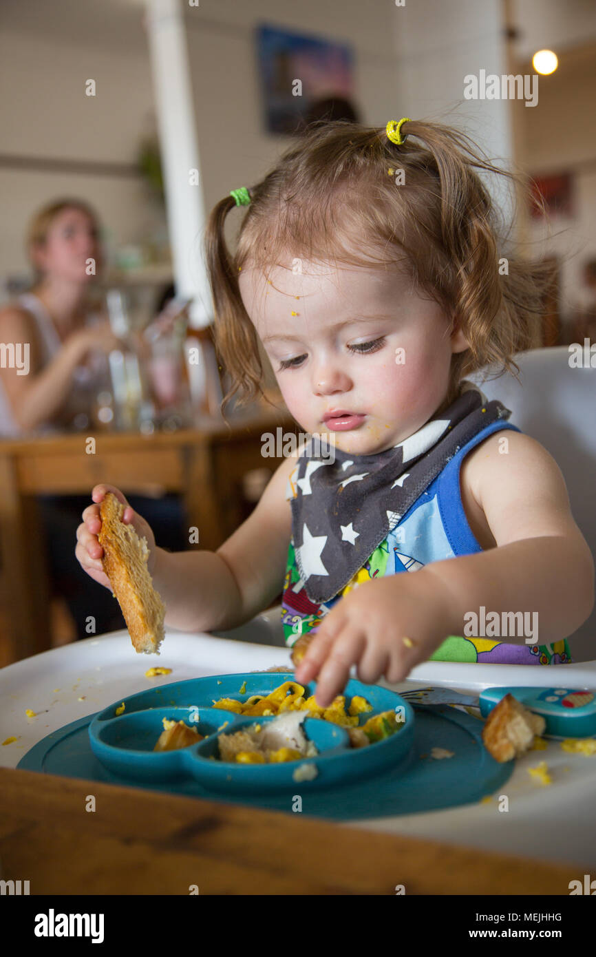 14 month old eating lunch in a cafe Stock Photo - Alamy