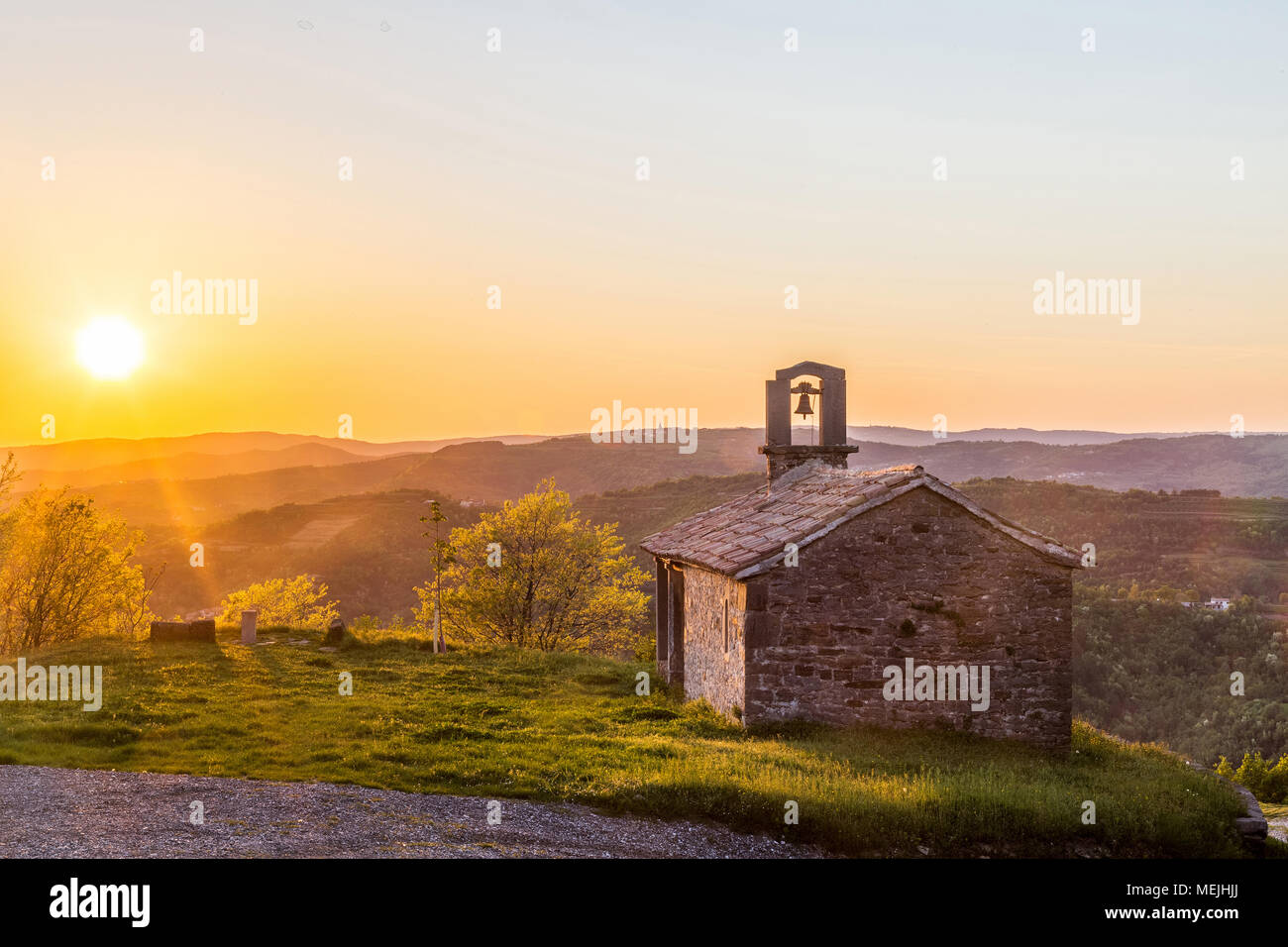 Church Sv. Rok in Draguc, Istria, Croatia in spring sundown. Shot against evening sun with visible lens flare Stock Photo