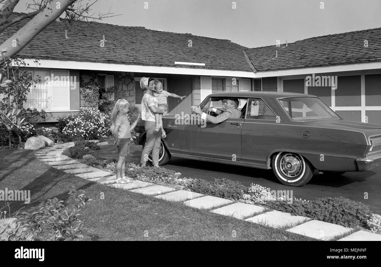 A perfect father waves to the perfect family on his way to work in Southern Calfornia, ca. 1965. Stock Photo