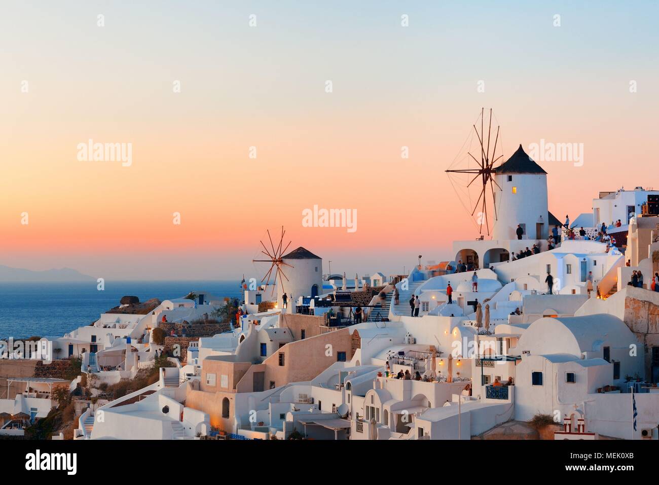Santorini skyline sunset with windmill and buildings in Greece. Stock Photo