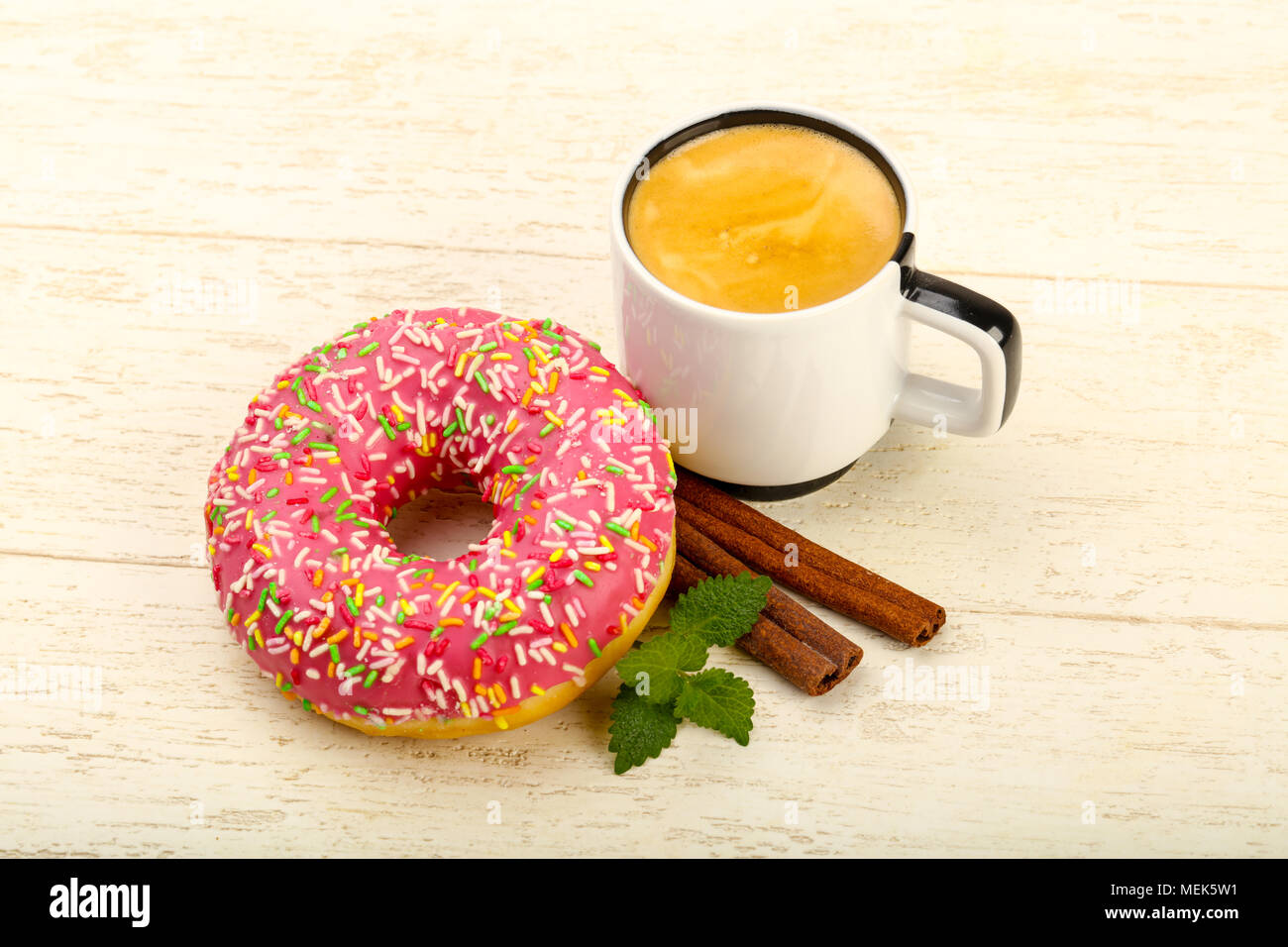 Pink Sweet iced donut over wooden background Stock Photo - Alamy