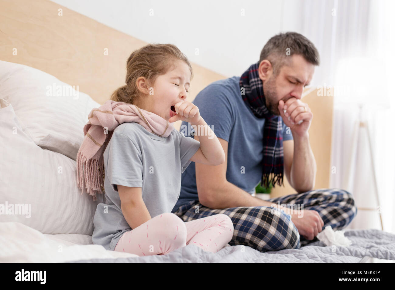 Sick father and daughter coughing Stock Photo Alamy