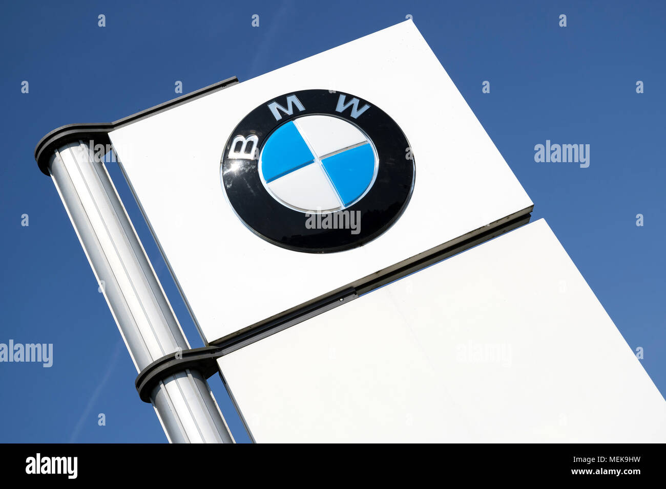 BMW dealership sign against blue sky. BMW is one of the best-selling luxury automakers in the world. Stock Photo