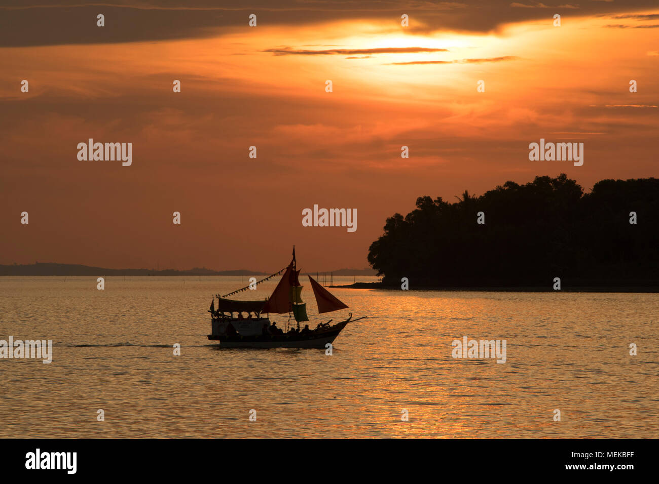 silhouette of nautical vessels against golden hour sunset Stock Photo