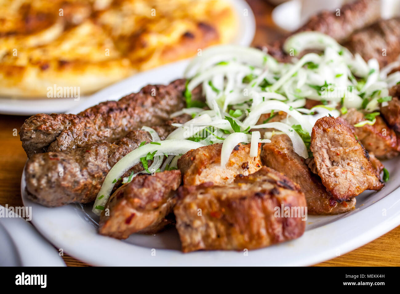 Traditional Georgian mtsvadi pork barbecue and Kebab with onion and