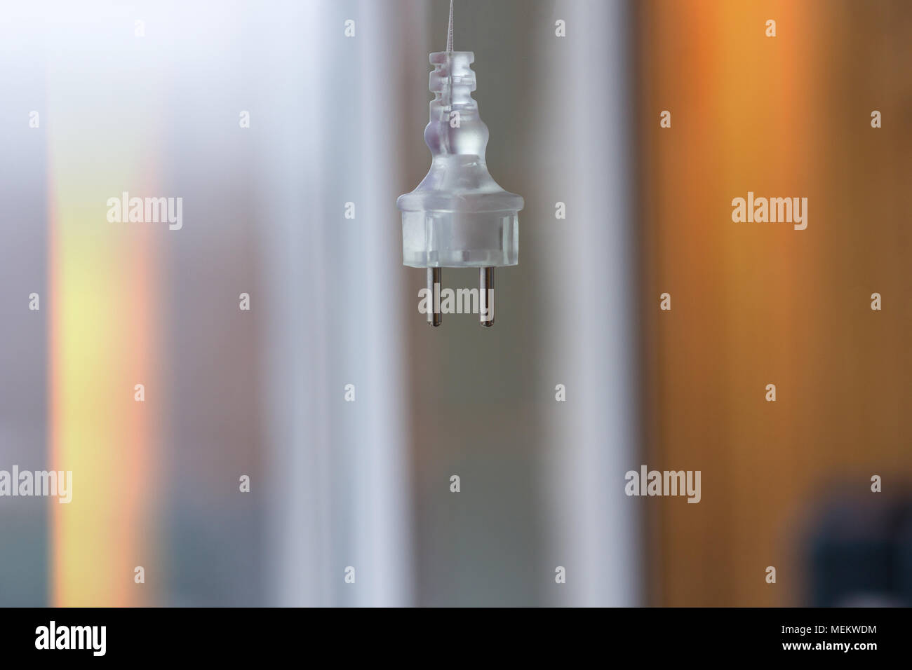 Electric plug on a blurred background hangs Stock Photo