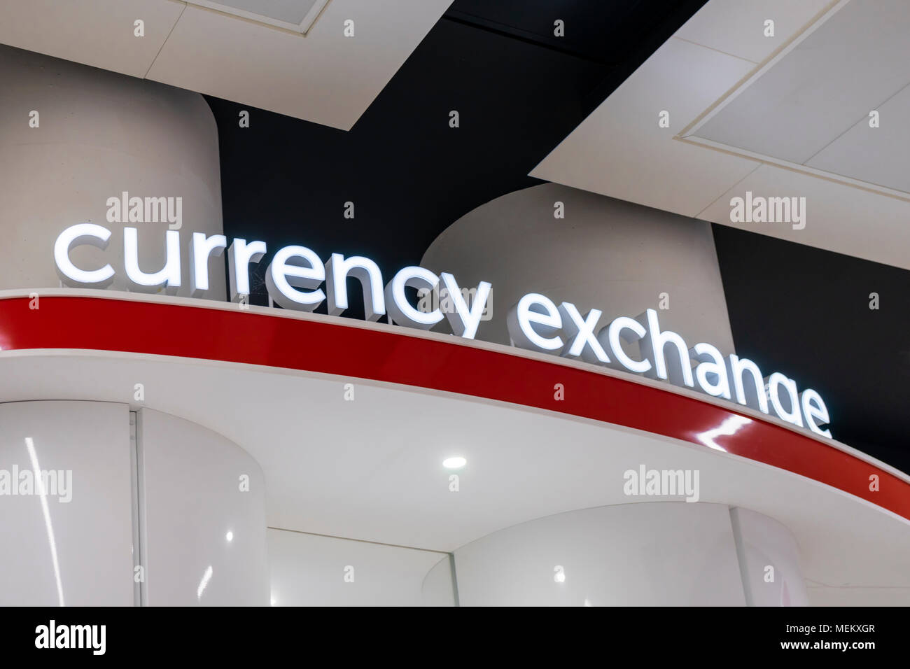 Currency exchange sign with illuminated white letters at an airport in the UK Stock Photo