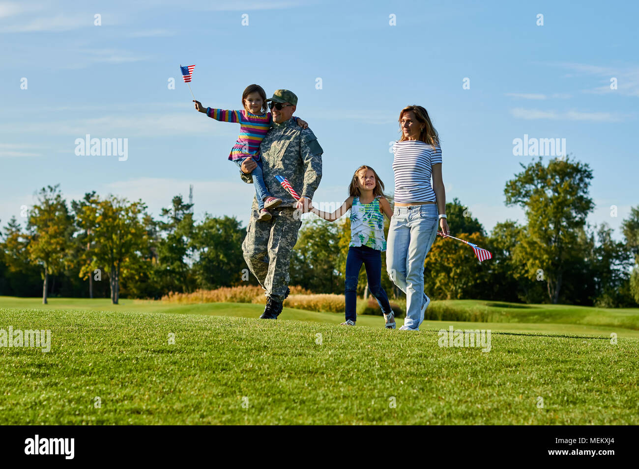 Patriotic family with usa flags. Stock Photo