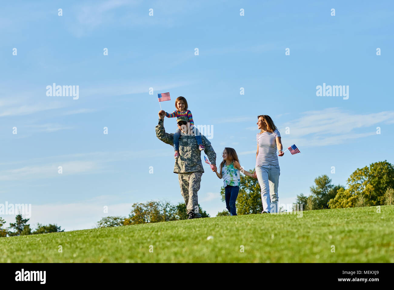 Happy soldier with family outdoors. Stock Photo