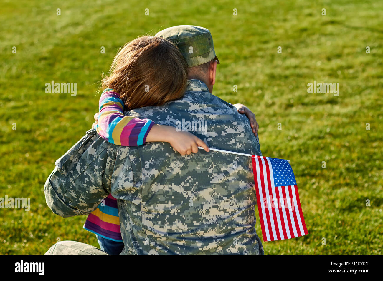 Touching US army soldier reunion with little daughter. Stock Photo