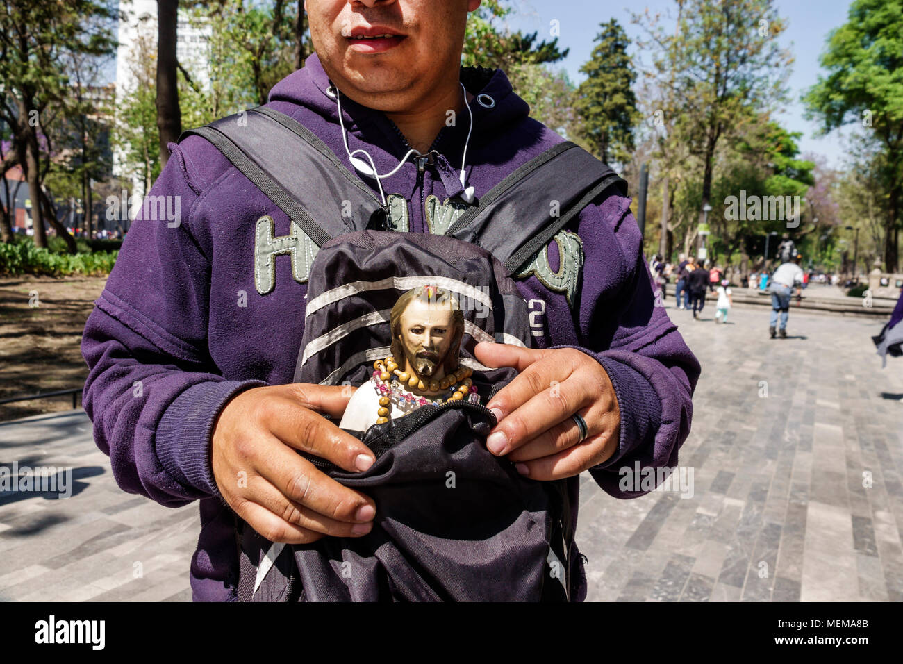 Mexico City,Mexican,Hispanic,historic Center Centre,Alameda Central,public park,man men male,walking,holding religious statue MX180304068 Stock Photo