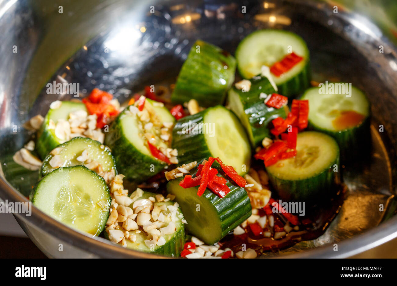 Chinese salad of beaten cucumbers with garlic, chili pepper, soy sauce and sesame oil Stock Photo