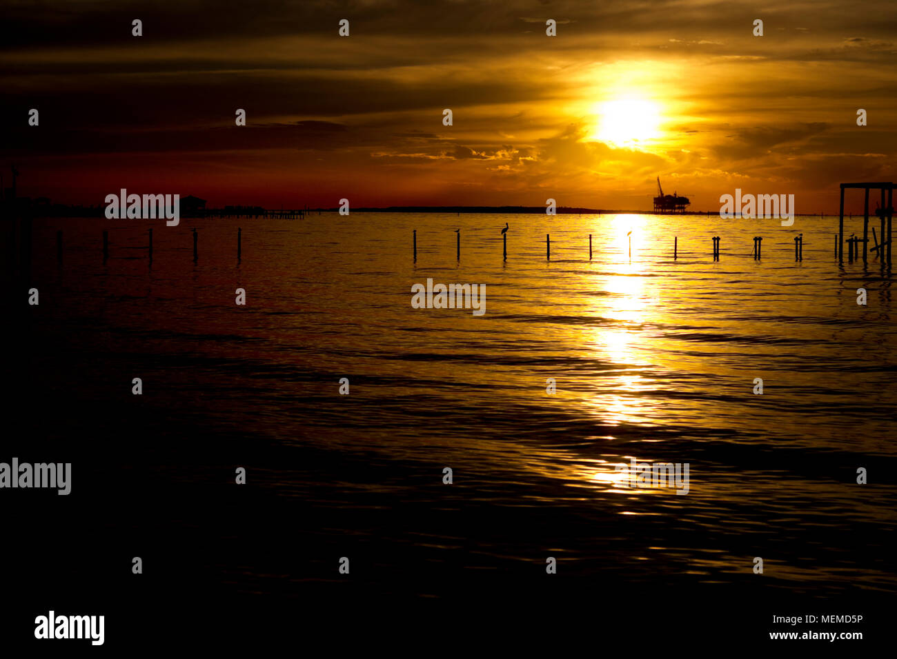 Sunset behind the ExxonMobil natural gas platform on Mobile Bay