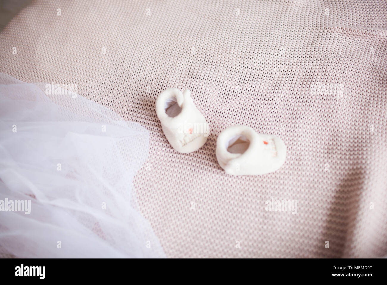 Baby shoes for newborn baby on the bed Stock Photo - Alamy