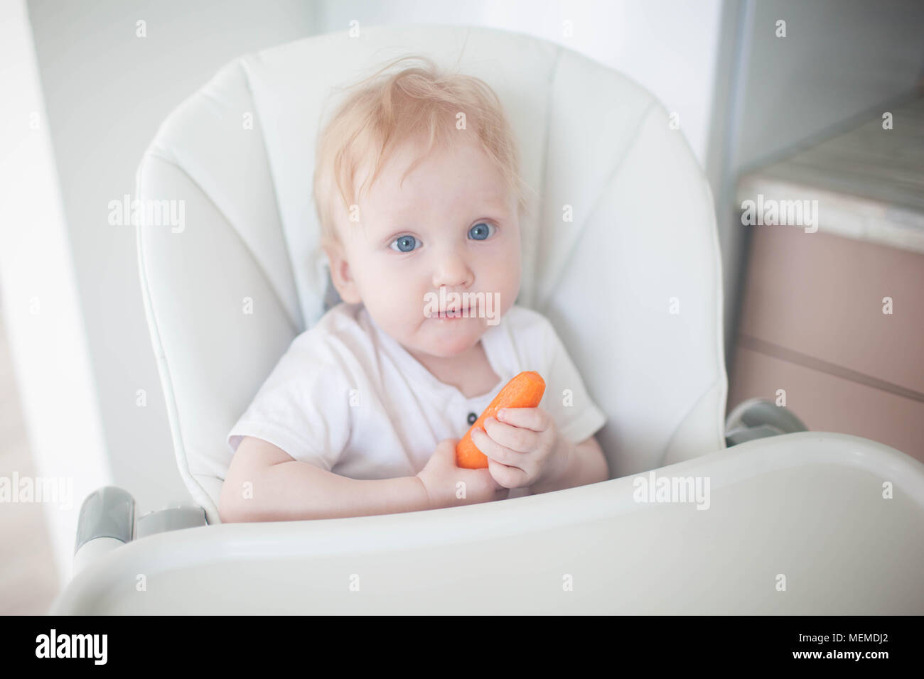 The baby is eating carrots Stock Photo Alamy