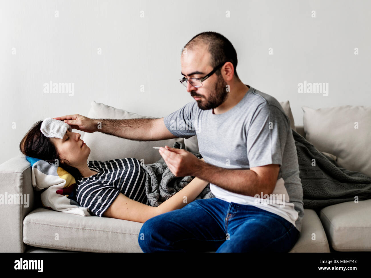 Couple sick at home on the sofa Stock Photo