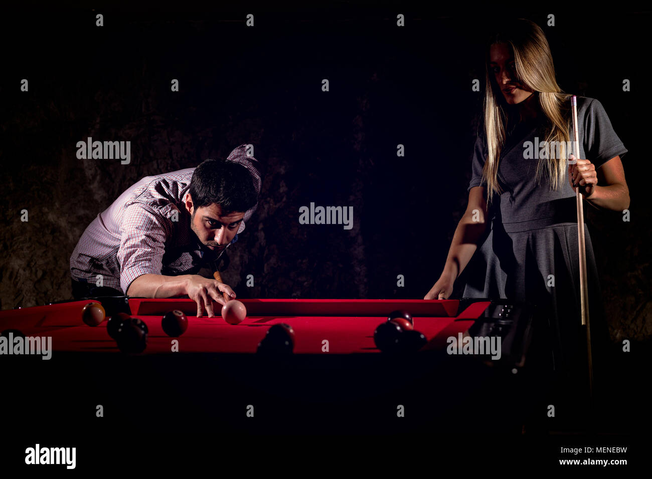 Young romantic couple playing billiard game Stock Photo