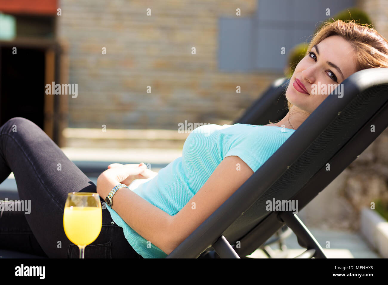 woman relaxing on lounger in the garden Stock Photo - Alamy