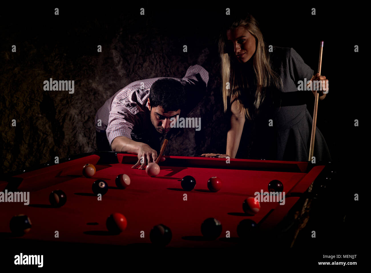 Young romantic couple playing billiard game Stock Photo