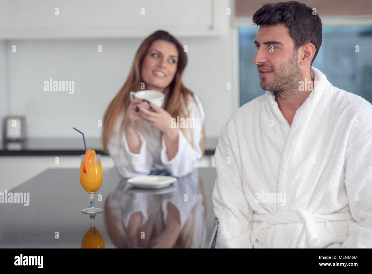 Portrait of a man and his wife in the kitchen while having breakf