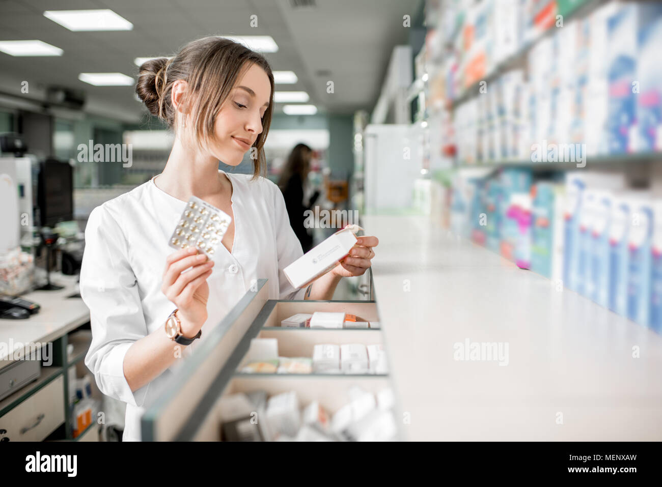 Pharmacist working in the pharmacy store Stock Photo