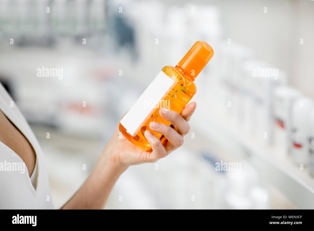 Taking sunscreen lotion at the pharmacy Stock Photo