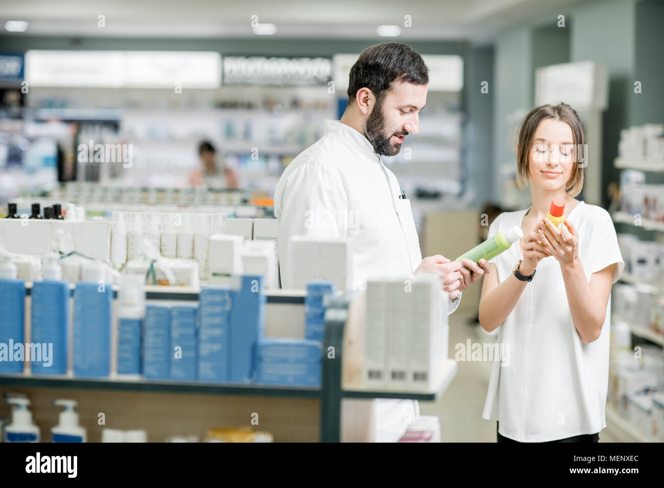 Pharmacist with client at the pharmacy store Stock Photo