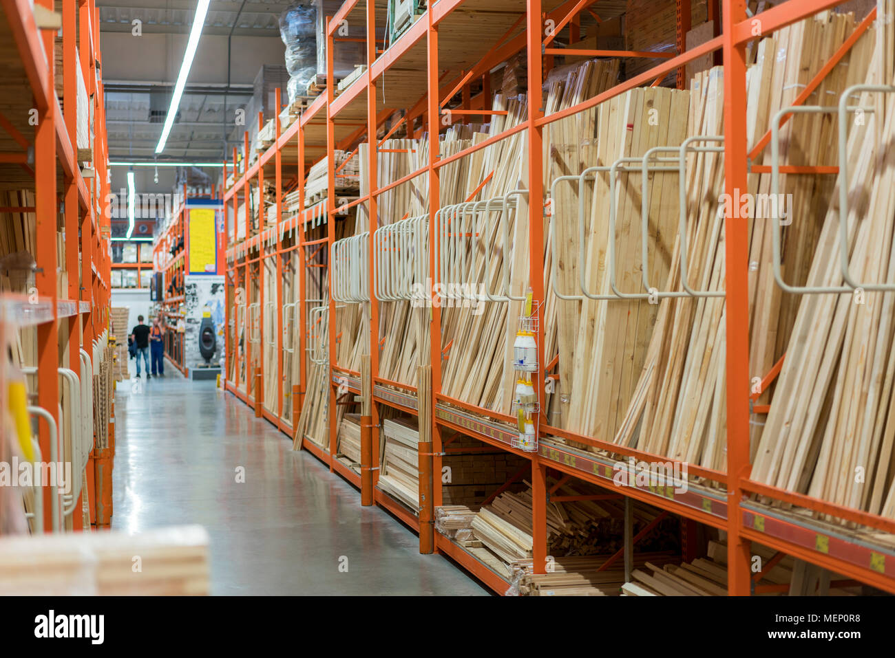 interior of hardware retailer with aisles, shelves, racks of building ...