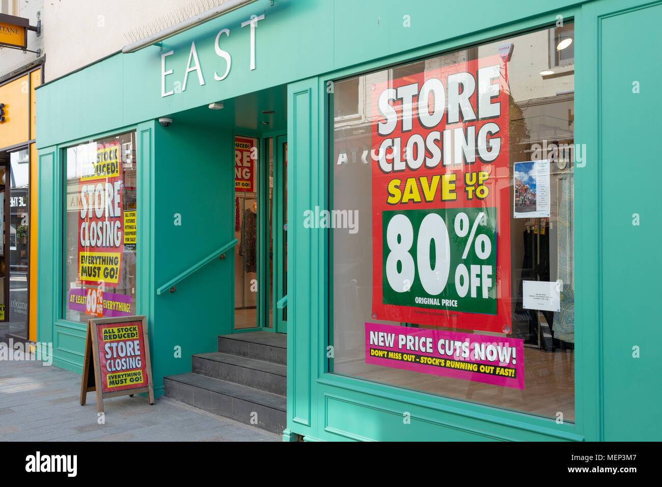 East women's fashion clothing store on Butcher Row, Salisbury, Wiltshire, UK with store closing window posters after going into administration. Stock Photo