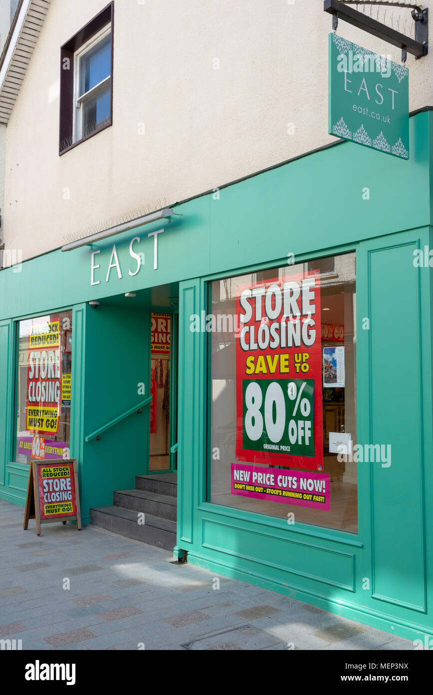 East women's fashion clothing store on Butcher Row, Salisbury, Wiltshire, UK with store closing window posters after going into administration. Stock Photo