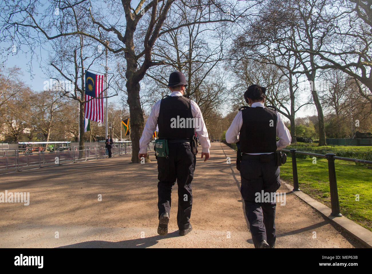 A policeman and a policewoman on patrol on The Mall in central London Stock Photo